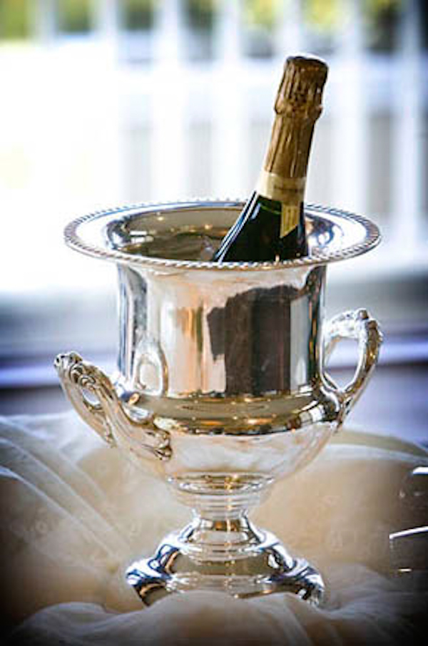Champagne bottle in silver ice bucket - wedding photo by J Garner Photography